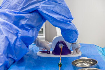 Disposable heart valve crimping tool. In the operating room, the doctor prepares the heart valve...