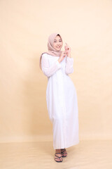 girl asian wearing beautiful dress smiling pose isolated on cream background - beauty, model, studio and fashion concept