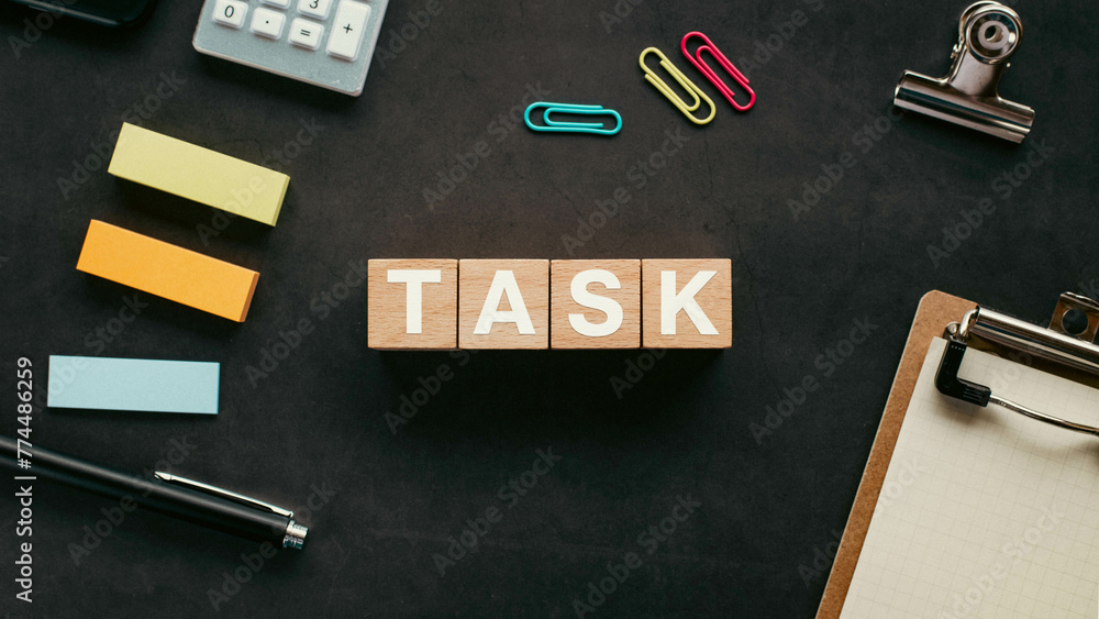 Poster there is wood cube with the word task. it is an abbreviation for task as eye-catching image.