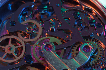 Close up detail of a macro clockwork inside a shiny iron wristwatch with sapphire rear glass bottom. - 774498433