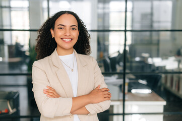 Female portrait. Successful confident beautiful curly haired business woman, corporate manager,...