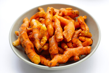 Turmeric roots on white background.