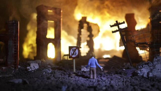 Concept of Peace: No War. A miniature ruined city after a nuclear catastrophe. A 'No War' sign stands beside a shocked person surrounded by the blazing ruins
