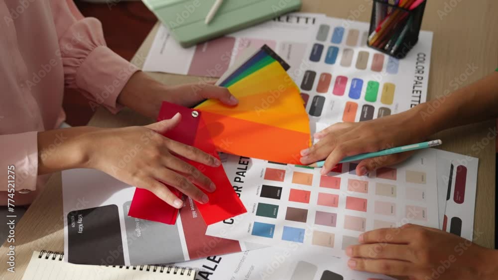 Poster slow motion hand closeup of two designer brainstorming and choosing color for graphic design working