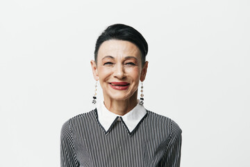 Portrait of a stylish woman in black and white striped shirt and earrings against white background - obrazy, fototapety, plakaty