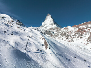 An aerial view of Zermatt, Switzerland, shows the Matterhorn and ski slopes with cable cars. The...