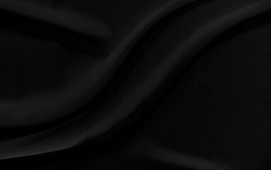 Black gray satin dark fabric texture luxurious shiny that is abstract silk cloth background with...