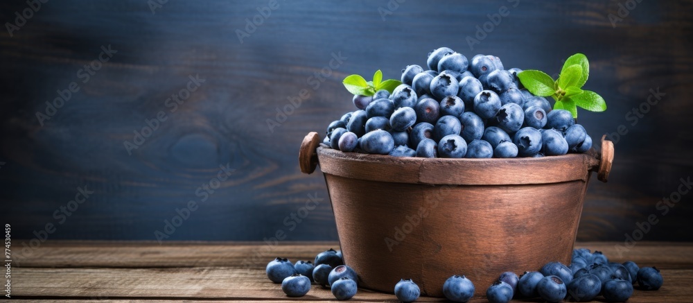 Poster a close-up view of a round wooden bucket overflowing with fresh and ripe blueberries, creating a col