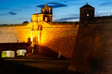 Night evening shot of citadel fortress of Jaca, illuminated by lanterns, located in picturesque mountainous area. Former capital of Aragon, San Pedro Castle