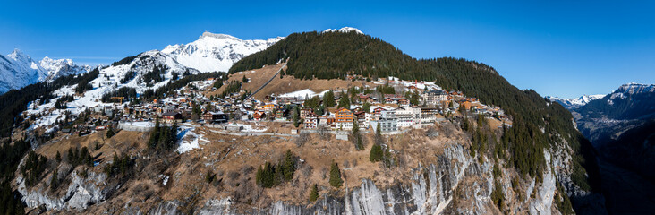 Panoramic view of Murren, Switzerland, with Swiss chalets and the Bernese Alps. Its cliffside charm...