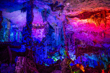 A natural cave in Guilin, China beautifully decorated with colorful lights