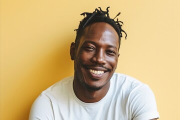 Portrait of handsome african american man smiling against yellow background - obrazy, fototapety, plakaty