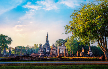 Sukhothai Buddhas and temples at sunset with dramatic sky in Sukhothai historical park, Thailand