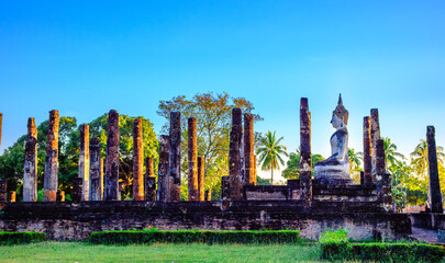 Sukhothai Buddhas and temples at sunset with dramatic sky in Sukhothai historical park, Thailand