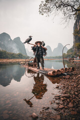 Chinese man fishing with cormorants birds, Yangshuo, Guangxi region