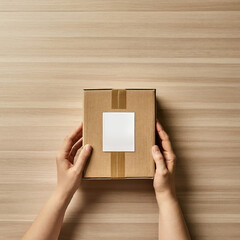Woman hands holding a cardboard box on wooden background. Top view.