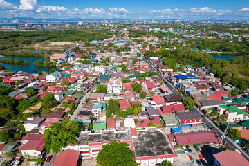 Kawit, Cavite, Philippines - Aerial of the town of Kawit, with the Metro Manila skyline in the...