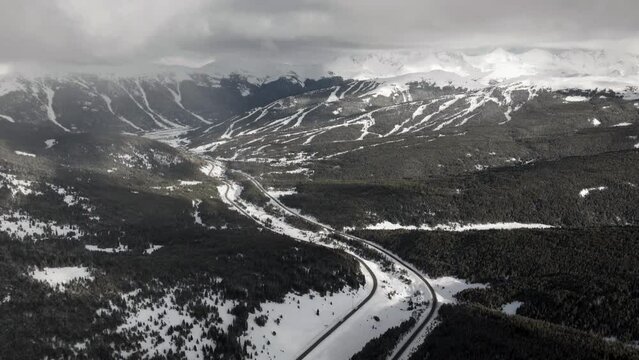 Vail pass i70 highway perspective of sky chutes Copper Mountain ski resort trail runs ten mile range Leadville Colorado ikon snowy winter spring snowy peaks evening clouds sunset forward reveal motion