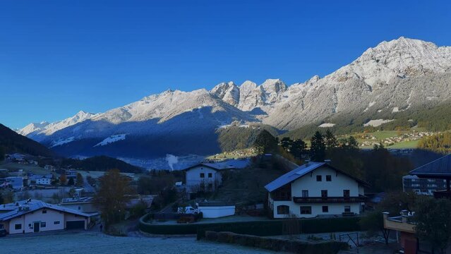 Early November Europe Australian Swiss Alps fall autumn Stubai Village chalet Tirol Austria first light morning sunny shaded first snow on peaks cloudy foggy Innsbruck chalet landscape pan left