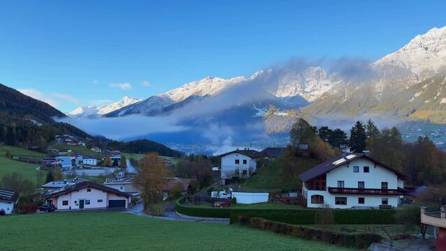 Early November Europe Australian Swiss Alps fall autumn Stubai Village chalet Tirol Austria first light morning sunny sunrise first snow on peaks cloudy foggy Innsbruck chalet landscape pan left