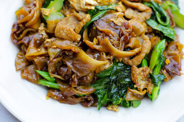 Stir-fried rice noodles with soy sauce and pork