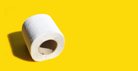 Toilet paper on yellow background.
