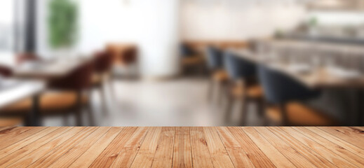 Empty wood tabletop or counter with display product. Blur image of restaurant interior background.