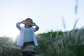 Lifestyle woman Enjoy Nature. Healthy Smiling Girl in Green Grass.