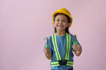 Little handyman with tools Cute child is a construction worker playing with a screwdriver, hammer,...