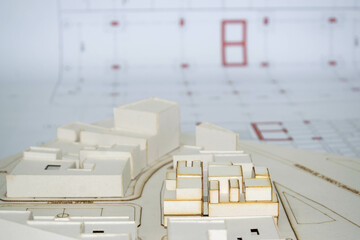 Architectural model made of white strawboard with architectural, technical and constructive background plans