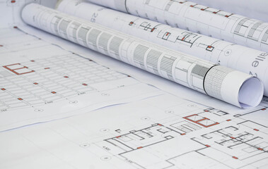 Architectural project on rolled-up construction plans