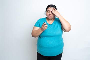 Overweight fat indian woman get stressed due to high blood sugar level test. Hands on head....