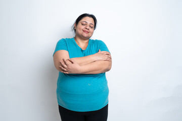 Overweight fat indian standing smiling touching body stress free, mental health isolated over white...