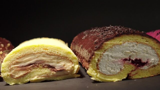 slider shot of cake rolls brazo gitano swiss roll desserts collection chocolate ferrero cheese butter jelly berries cherry with black background