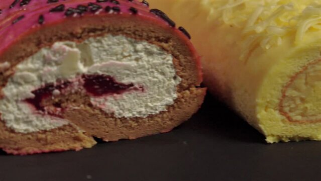 Close up detail shot slider of slider shot of cake rolls brazo gitano swiss roll desserts collection chocolate ferrero cheese butter jelly berries cherry with black background