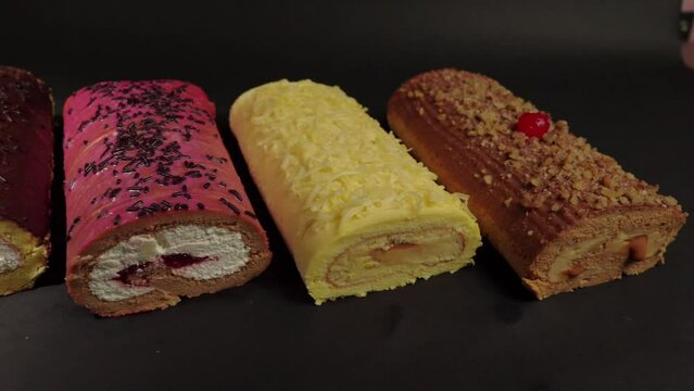 top view flat shot of slider shot of cake rolls brazo gitano swiss roll desserts collection chocolate ferrero cheese butter jelly berries cherry with black background