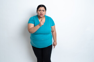 Angry Overweight indian woman pointing finger. against white background. aggressive Plus size...