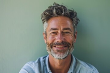 Portrait of handsome senior man with grey hair smiling at the camera