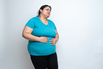 Overweight fat indian woman hand on stomach felling unwell because of indigestion ache. isolated...