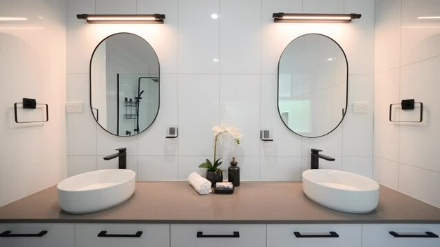 Minimalistic Luxury Double Dual Vanity Bathroom with Modern Appliances and Individual Counter Spaces. Interior of house home for real estate property.