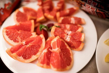 Juicy grapefruit slices arranged on a white plate
