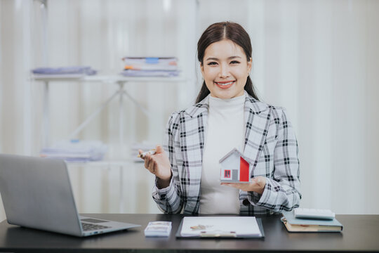Businesswoman or sales representative presenting a home purchase contract to buy a house or apartment and mortgage, money and finance concept. Buy or sell mortgaged real estate