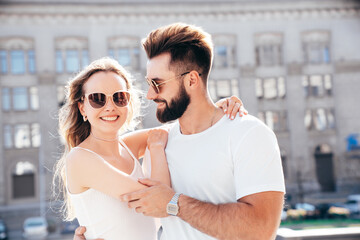 Smiling beautiful woman and her handsome boyfriend. Woman in casual summer clothes. Happy cheerful family. Female having fun. Couple posing in street at sunny day. Having tender moments