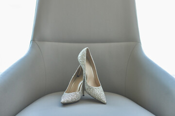 Elegant bridal heels with intricate lace detailing, poised gracefully.