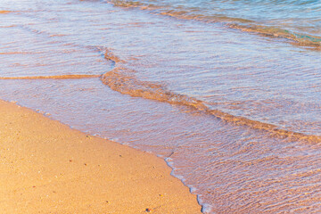 Soft wave of the sea on the sandy beach.