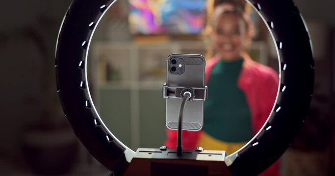 Influencer, phone and woman blow kiss for live streaming audience on social media, mobile app and website. Night, home and person with ring light record on smartphone for internet, networking or vlog