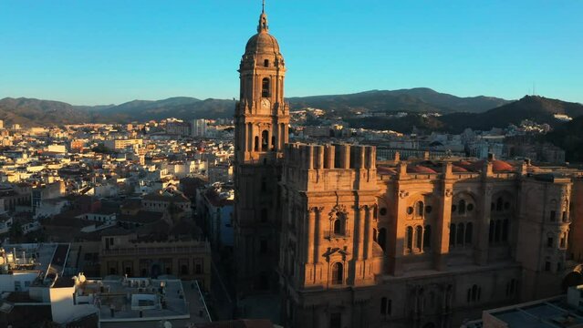 Panoramic aerial drone of Malaga Cathedral architecture in Spain religious city landmark, christianity, church hills and sunset skyline background