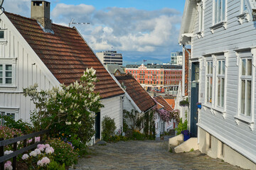 historic street with beautiful traditional white wooden houses in Gamle Stavanger in Rogaland,...