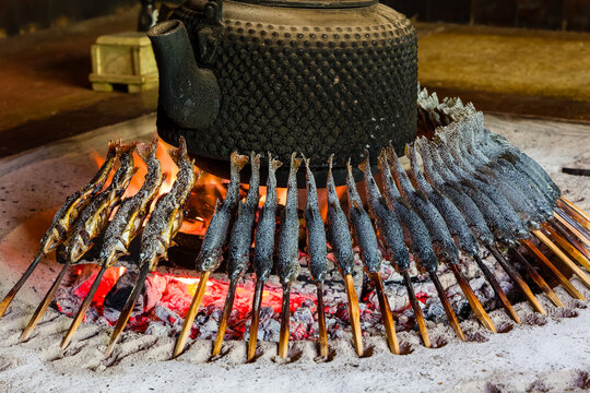Grilled Char (Iwana) cooking on a traditional Japanese fireplace
