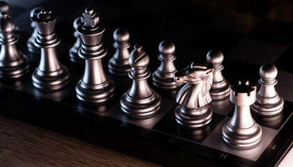 Angled view of chess pieces on board.